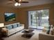 Virtually staged living room with comfy sofas and a view of the water at 2411 Aspinwall St # 2411, Sarasota, FL 34237