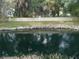 Serene canal view with lush vegetation and a wall at 2411 Aspinwall St # 2411, Sarasota, FL 34237