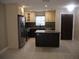 Modern kitchen with stainless steel appliances and an island at 2411 Aspinwall St # 2411, Sarasota, FL 34237