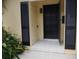 Private condo entrance with black door and shutters at 2411 Aspinwall St # 2411, Sarasota, FL 34237