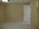Simple bedroom with tiled floors and neutral wall colors at 2411 Aspinwall St # 2411, Sarasota, FL 34237