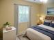 Bedroom with bed, nightstand and window at 2411 Aspinwall St # 2411, Sarasota, FL 34237