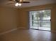 Bright living room with tiled floors and sliding glass doors leading to a patio at 2411 Aspinwall St # 2411, Sarasota, FL 34237