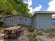 Backyard with patio and wooden dining set under large tree at 2439 Loma Linda St, Sarasota, FL 34239