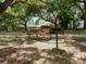 Park picnic table and grill under shady oak trees at 2439 Loma Linda St, Sarasota, FL 34239