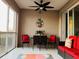 Outdoor balcony dining area with seating for four and a ceiling fan at 395 Aruba Cir # 102, Bradenton, FL 34209