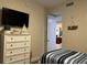 Bedroom with twin bed, dresser, and TV at 395 Aruba Cir # 102, Bradenton, FL 34209