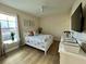 Bedroom with full bed, TV, and coastal decor at 395 Aruba Cir # 102, Bradenton, FL 34209