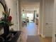 Hallway view of living room with hardwood floors and access to other rooms at 395 Aruba Cir # 102, Bradenton, FL 34209