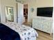 Main bedroom with king-size bed and view into the kitchen at 395 Aruba Cir # 102, Bradenton, FL 34209