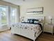 Main bedroom with king bed, neutral decor, and ample natural light at 395 Aruba Cir # 102, Bradenton, FL 34209