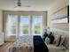 Bright main bedroom with king-size bed, large windows, and water views at 395 Aruba Cir # 102, Bradenton, FL 34209