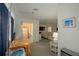 Open-concept living space with kitchen, dining, and bedroom at 7730 Manasota Key Rd, Englewood, FL 34223
