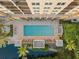 Elevated view of resort-style pool and spa at 750 N Tamiami Trl # 1115, Sarasota, FL 34236
