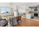 Open concept living room and kitchen with hardwood floors and water views at 750 N Tamiami Trl # 1115, Sarasota, FL 34236