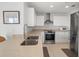 Modern kitchen with stainless steel appliances and light-colored cabinetry at 750 N Tamiami Trl # 1115, Sarasota, FL 34236