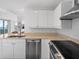 Modern kitchen with stainless steel appliances and light wood cabinets at 750 N Tamiami Trl # 1115, Sarasota, FL 34236