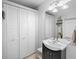 Clean bathroom with white vanity and built-in shelving at 750 N Tamiami Trl # 1115, Sarasota, FL 34236