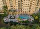 Aerial view of resort-style pool with surrounding patio at 750 N Tamiami Trl # 1115, Sarasota, FL 34236