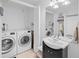 Convenient laundry room with washer, dryer, and storage at 750 N Tamiami Trl # 1115, Sarasota, FL 34236