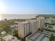 Aerial view of a luxury high-rise building near the waterfront at 750 N Tamiami Trl # 1115, Sarasota, FL 34236