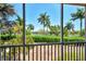 Serene waterfront view with lush tropical landscaping at 395 Aruba Cir # 102, Bradenton, FL 34209