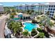 Resort-style pool with lounge chairs, landscaping, and nearby community building at 395 Aruba Cir # 102, Bradenton, FL 34209