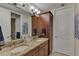 Double vanity bathroom with granite countertops and a large mirror at 395 Aruba Cir # 102, Bradenton, FL 34209