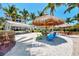 Relaxing shaded seating area with picnic tables and thatch umbrellas at 395 Aruba Cir # 102, Bradenton, FL 34209