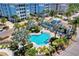 Relaxing kidney-shaped pool with surrounding lounge chairs and palm trees at 395 Aruba Cir # 102, Bradenton, FL 34209