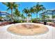 Circular fountain with compass rose design, surrounded by palm trees at 395 Aruba Cir # 102, Bradenton, FL 34209