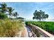 Wooden boardwalk path leading to waterfront with lush landscaping at 395 Aruba Cir # 102, Bradenton, FL 34209