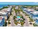 Aerial view showing community pool, surrounding buildings, and ample parking at 395 Aruba Cir # 102, Bradenton, FL 34209