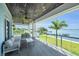 Covered balcony with outdoor seating and scenic water views at 327 Riverpoint Ne Dr, Bradenton, FL 34208