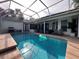 Inviting pool area with screened enclosure, lounge chairs, and a spacious deck at 5285 Far Oak Cir, Sarasota, FL 34238