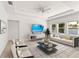 Bright living room featuring comfy seating and a large TV at 1800 Robinhood St, Sarasota, FL 34231