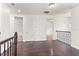 Upstairs hallway with hardwood floors and access to bedrooms at 1800 Robinhood St, Sarasota, FL 34231