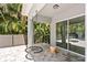 Covered patio with a hanging swing and lush greenery at 1800 Robinhood St, Sarasota, FL 34231