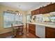 Kitchen with wood cabinets, white appliances and breakfast bar at 4215 Caddie E Dr # 101, Bradenton, FL 34203