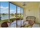 Sunroom with lake view and wicker furniture at 4215 Caddie E Dr # 101, Bradenton, FL 34203