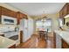 Kitchen with wood cabinets, white appliances and breakfast nook at 4215 Caddie E Dr # 101, Bradenton, FL 34203