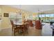 Bright dining room with wooden table and chairs, and view to the lake at 4215 Caddie E Dr # 101, Bradenton, FL 34203