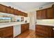 Kitchen with wooden cabinets, white appliances, and a breakfast bar at 4215 Caddie E Dr # 101, Bradenton, FL 34203