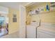 Laundry room with washer, dryer and storage shelves at 4215 Caddie E Dr # 101, Bradenton, FL 34203