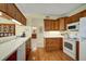 Kitchen with wood cabinets and white appliances at 4215 Caddie E Dr # 101, Bradenton, FL 34203