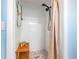 This bathroom features a pebble tile floor, a wood bench and a rainfall shower head at 5900 Driftwood Ave, Sarasota, FL 34231