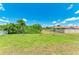 Large backyard with grassy lawn and surrounding landscape at 8380 Malcolm Ave, North Port, FL 34287