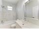 Clean bathroom with a bathtub, marble tile and quartz countertop at 8380 Malcolm Ave, North Port, FL 34287