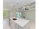 Open concept kitchen with island, stainless steel appliances, and white cabinets at 8380 Malcolm Ave, North Port, FL 34287