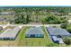Aerial view of a single-Gathering home with a gray roof and a large backyard at 8380 Malcolm Ave, North Port, FL 34287